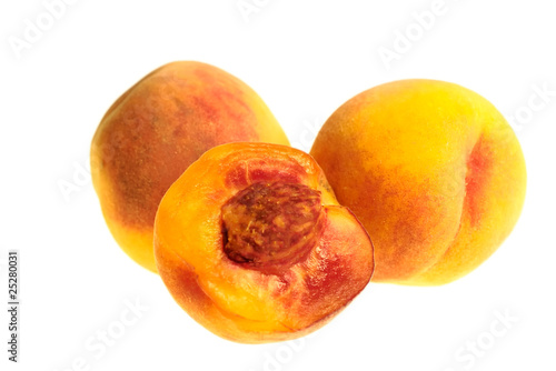 2,5 fresh peaches on white background