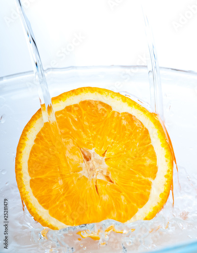 Fototapeta Naklejka Na Ścianę i Meble -  orange into water splash