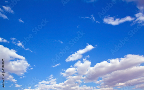 Scattered white clouds with bright blue background