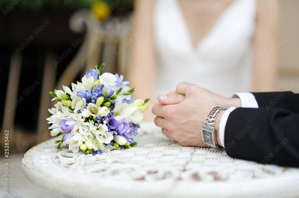 Groom's hands and wedding bouquet Groom's hands and wedding bouquet