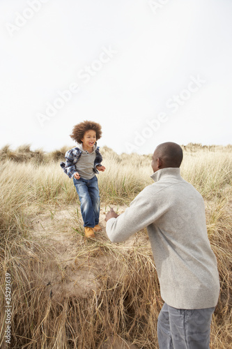 Father And Son Having Fun In Sand Dunes © micromonkey