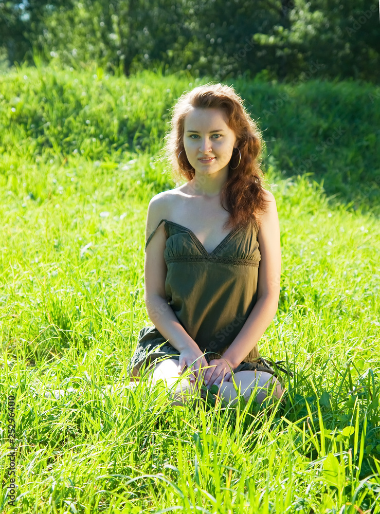 Fototapeta premium Pretty girl in grass outdoor