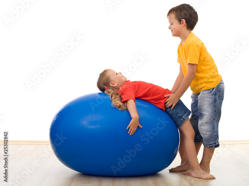 Trust my sister - kids playing with large rubber ball