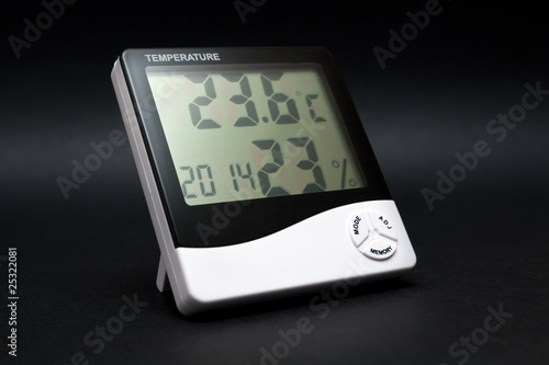 Black and white thermometer on black background.