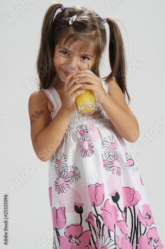 cute girl drinking orange juice photo