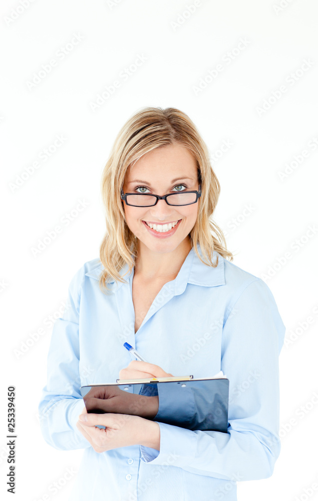 Smiling businesswoman wearing glasses and holding a clipboard Smiling businesswoman wearing glasses and holding a clipboard