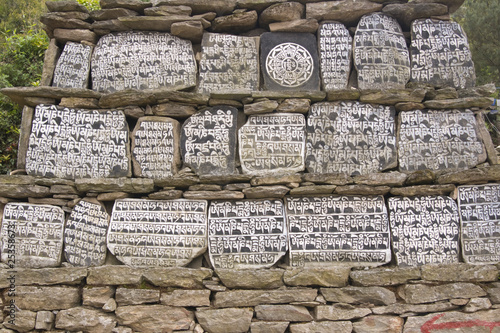 Buddhist Mani stones inscribed with religious text in Nepal photo