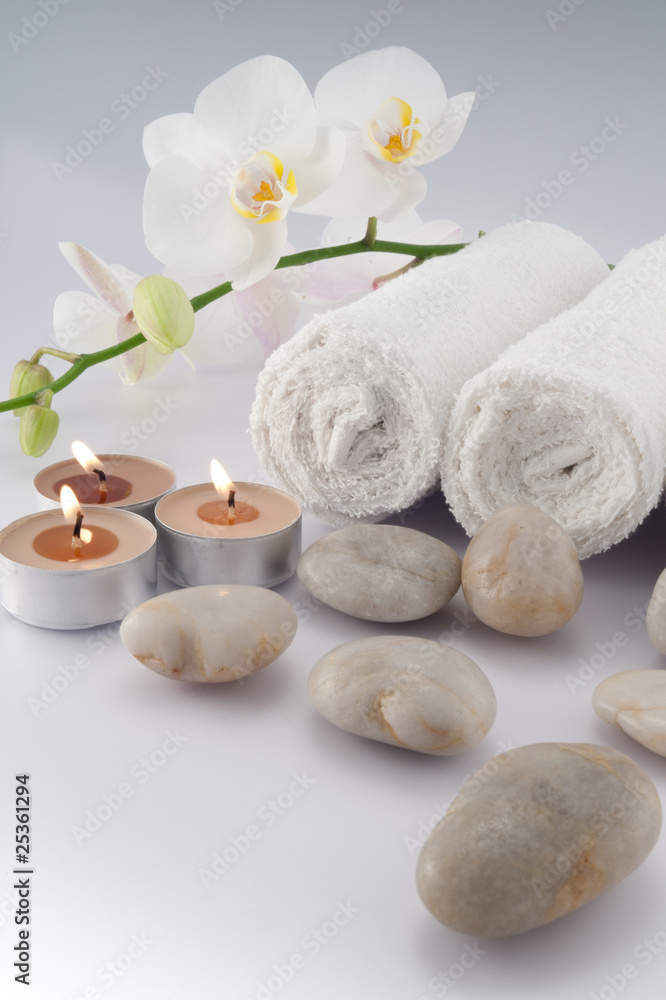 White towels with orchid, stones and candle