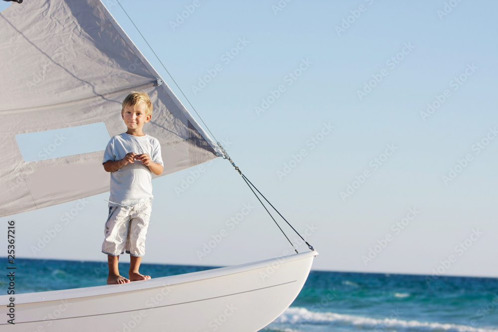 young boy onboard sea yacht