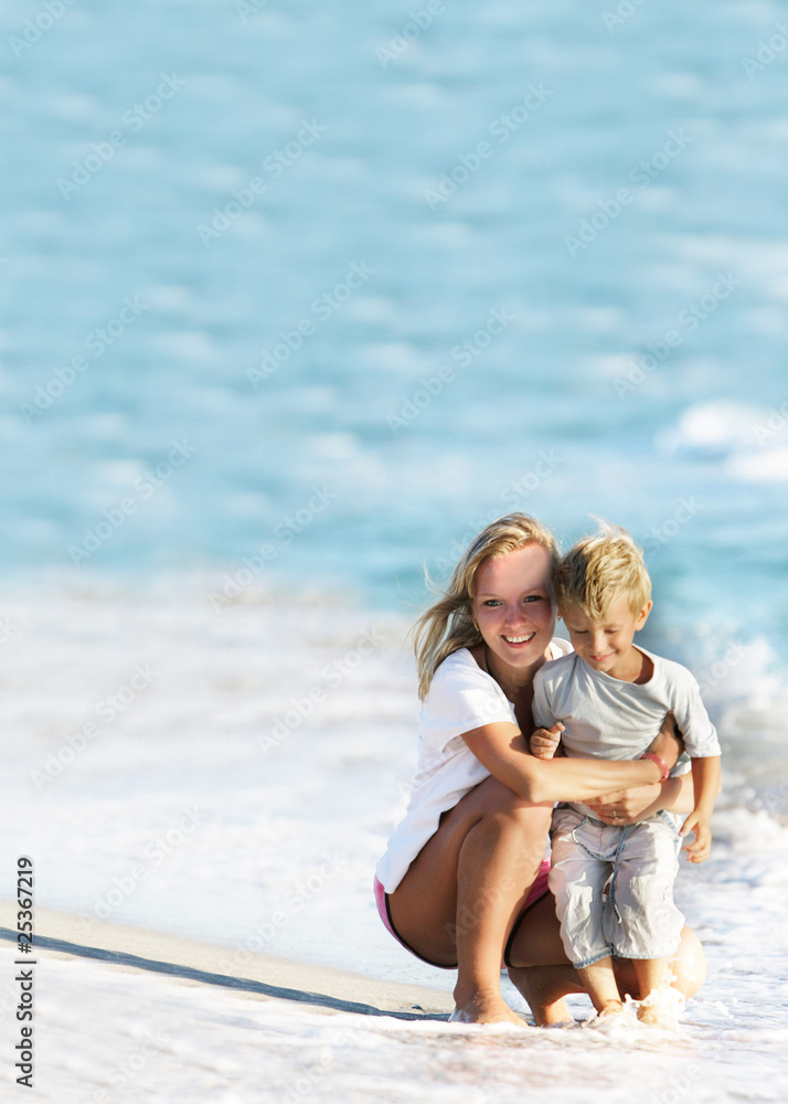 happy mother and son on beach