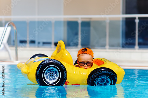cute toddler boy have a fun in pool outdoor