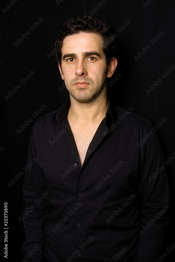 Portrait of young attractive man on a black background Portrait of young attractive man on a black background