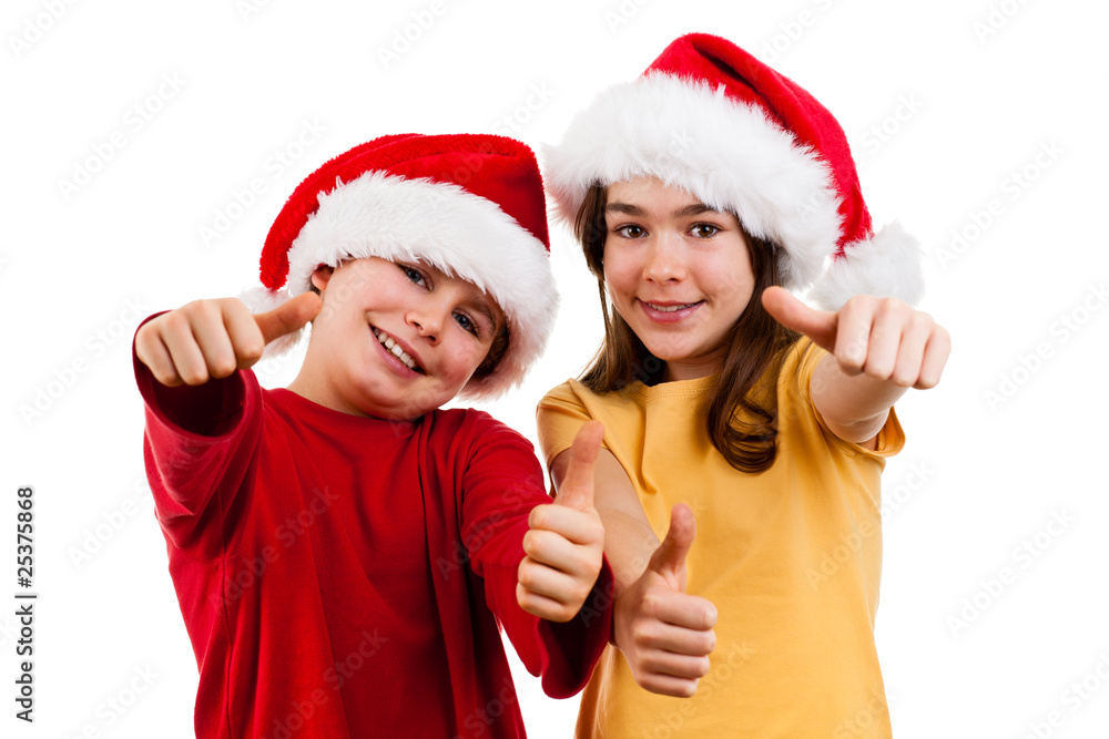 Kids wearing Santa Claus hats showing OK sign , isolated Kids wearing Santa Claus hats showing OK sign , isolated