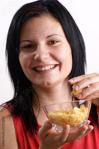 eine junge Frau isst Corn flakes
