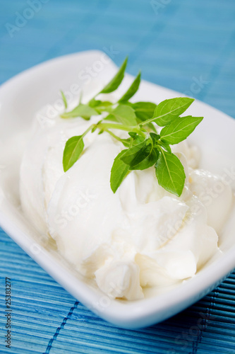 Sour cream with basil leaves