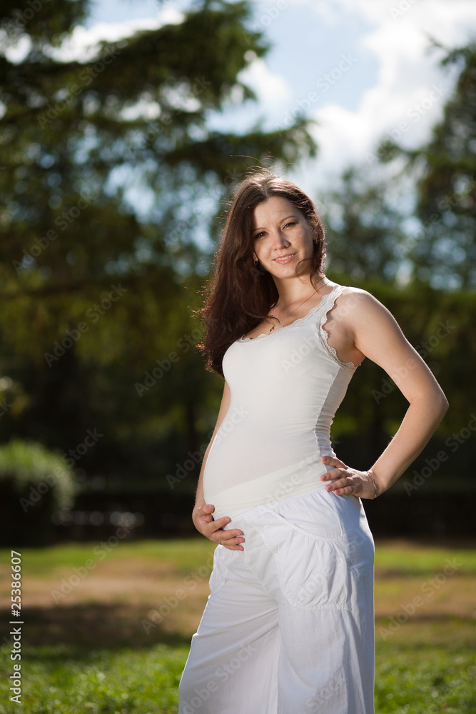Beautiful pregnant woman in park