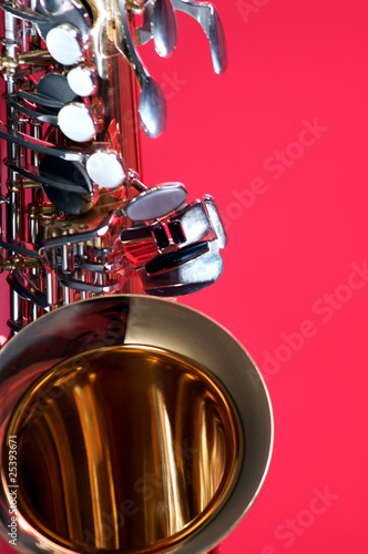 Gold Brass Saxophone Isolated on Red