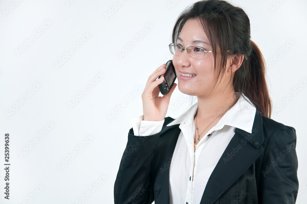 A chinese business woman on her cell phone A chinese business woman on her cell phone