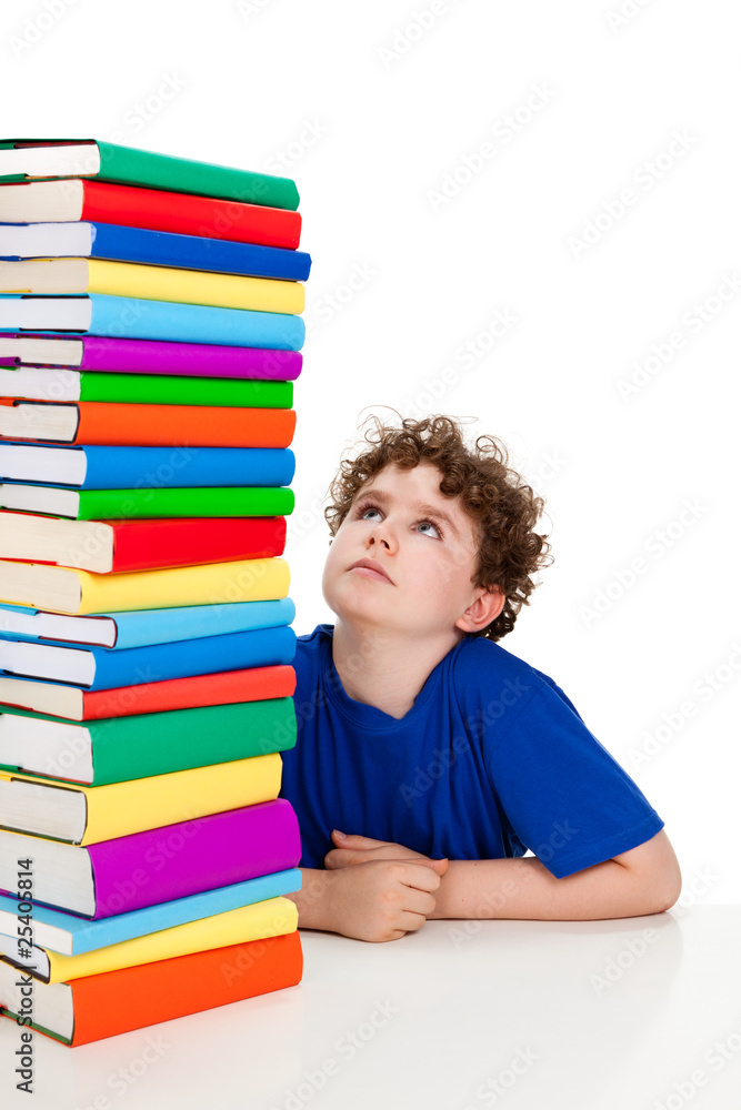Student sitting close to pile of books on white Student sitting close to pile of books on white