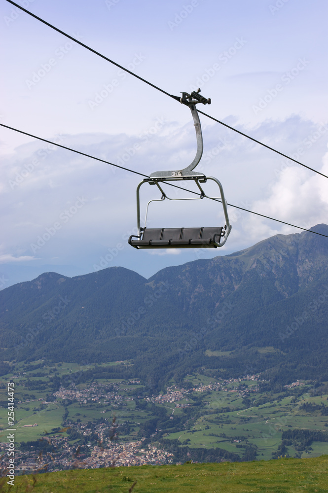 Chair-lift in the Italian Alps on a cloudy, summer day