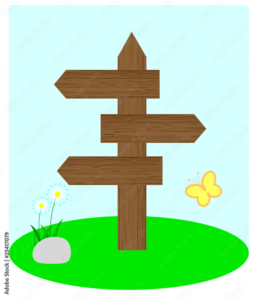 Wooden arrow standing on the grass Wooden arrow standing on the grass
