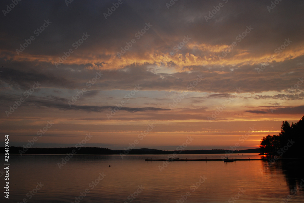 Sunset colours of the sky and water of lake Kuuhankavesi in Cent