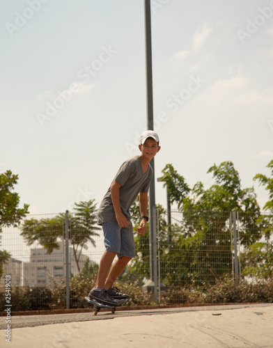 Young boy skateboarding .