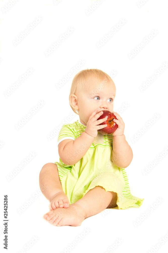 Young little baby eat red apple on white Young little baby eat red apple on white