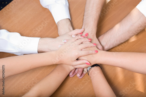 Office workers hold hands together