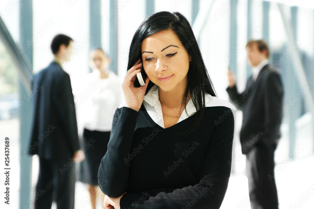 Four young business persons in a modern office Four young business persons in a modern office