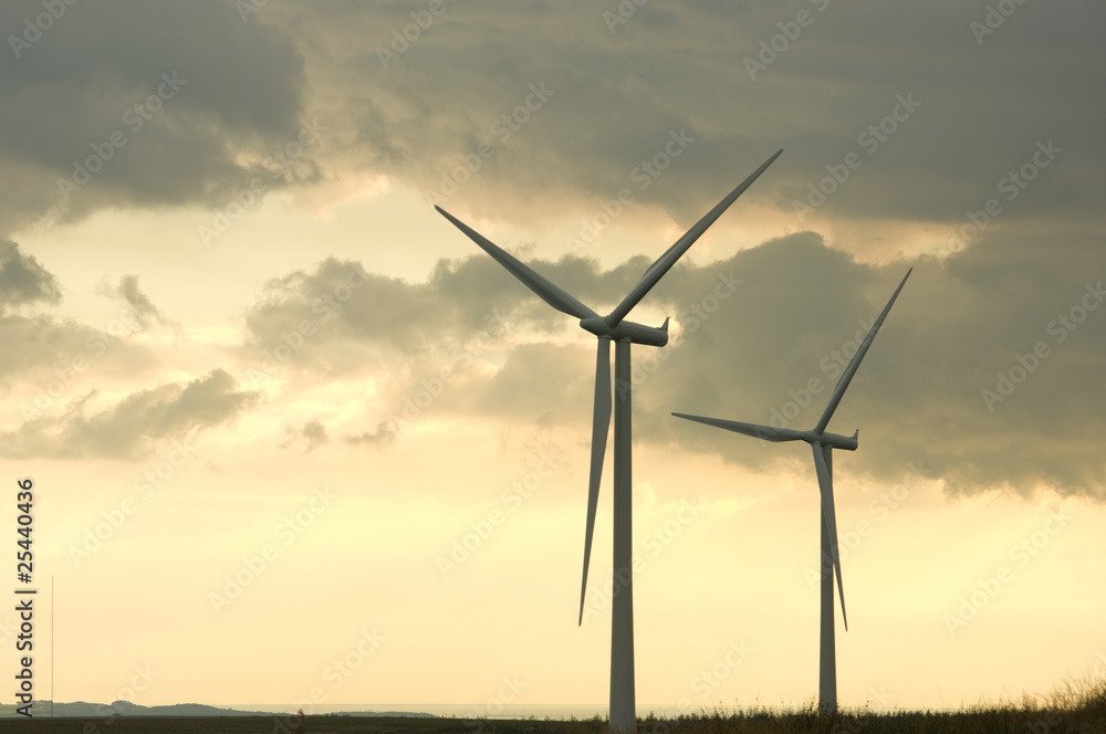 Two wind turbines at dusk