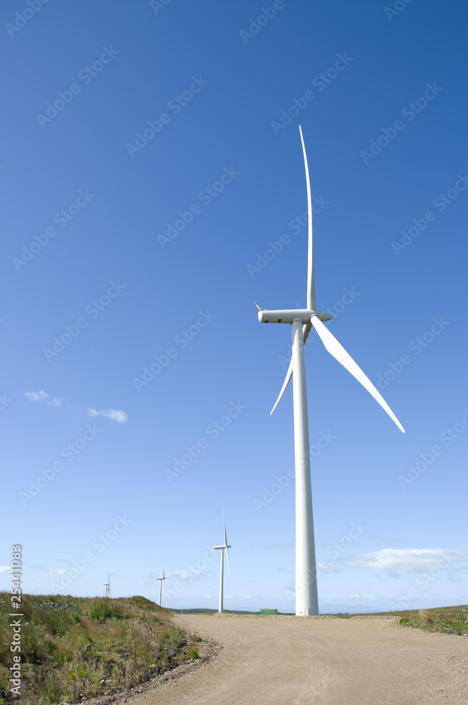 Four wind turbines in blue sky