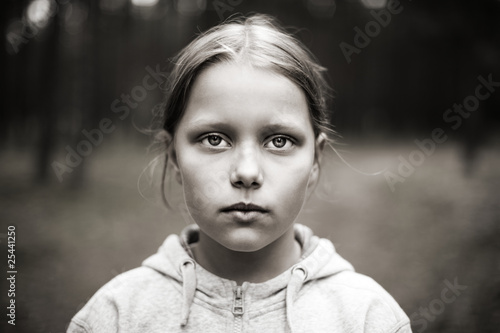 Black and white portrait of tired little girl with sad eyes.