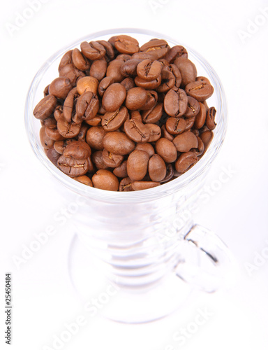 Glass of coffee beans on white background