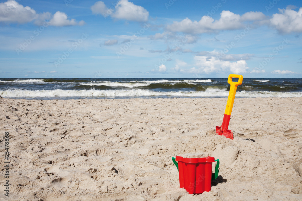 Children's beach toys - buckets, spade and shovel on sand Children's beach toys - buckets, spade and shovel on sand