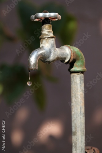 Vintage outdoor tap with droplet ready to fall