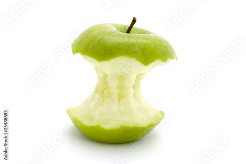 green apple core over white photo