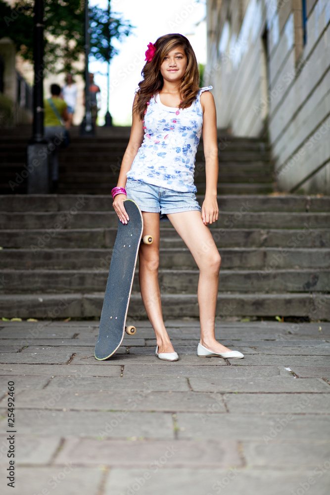 Teenage girl with her skateboard