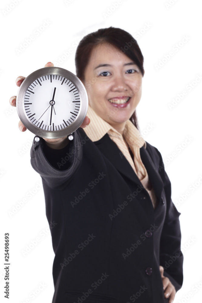 Asian Businesswoman holding a clock. Focus on the clock Asian Businesswoman holding a clock. Focus on the clock