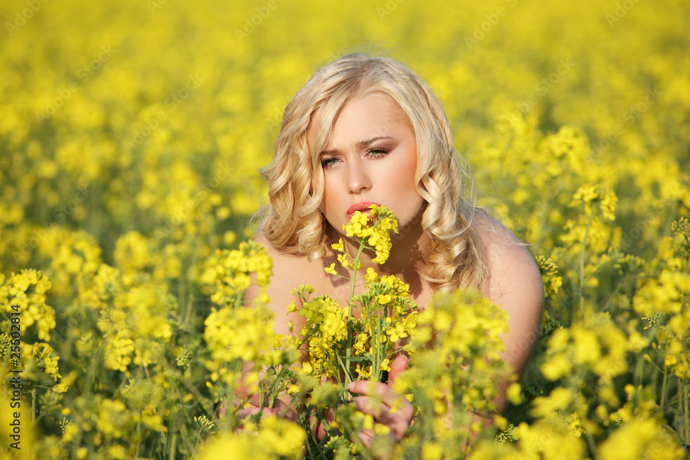 Beautiful young blonde woman in a field of wildflowers. Beautiful young blonde woman in a field of wildflowers.