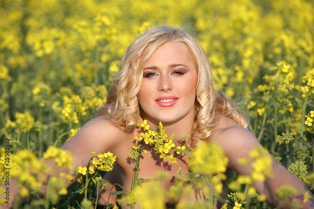 Beautiful young blonde woman in a field of wildflowers. Beautiful young blonde woman in a field of wildflowers.