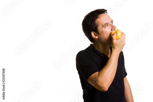 Young man eating a fresh red apple, isolated on white