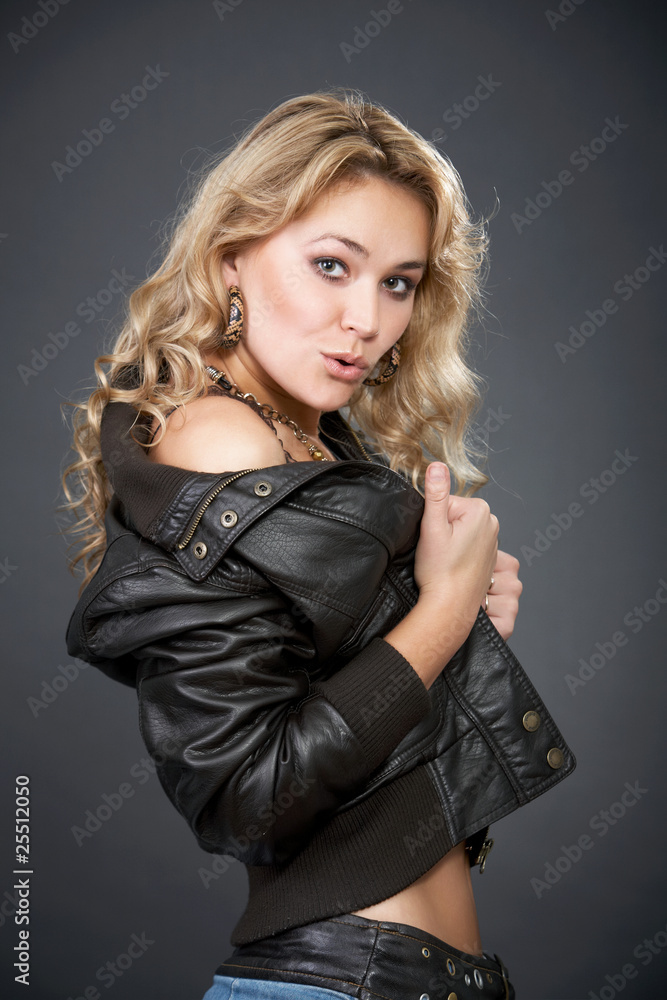 Sexy woman in a leather jacket and jeans skirt Stock Photo | Adobe Stock
