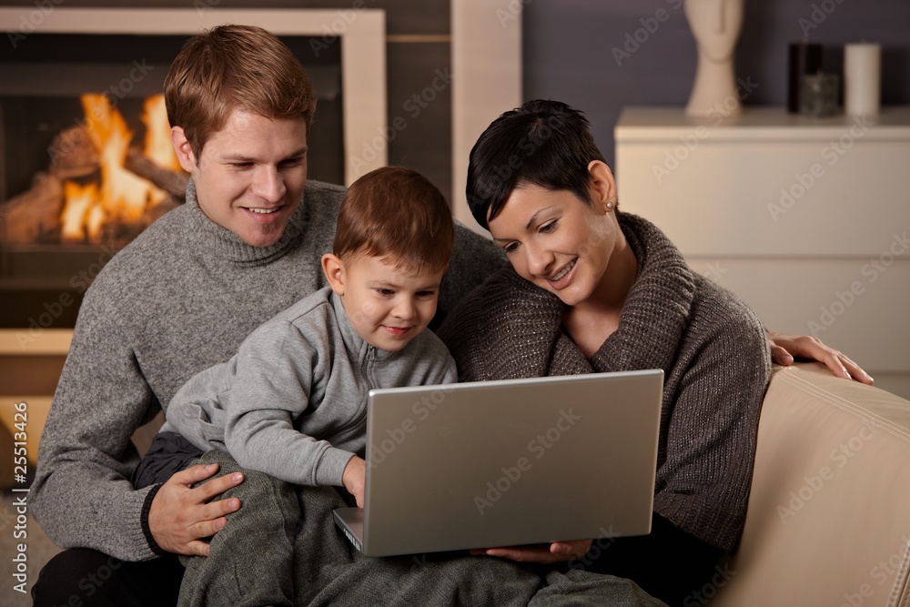 Happy family with computer