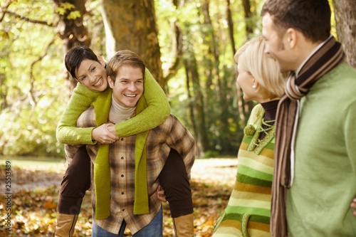 Two couples having fun in autumn park