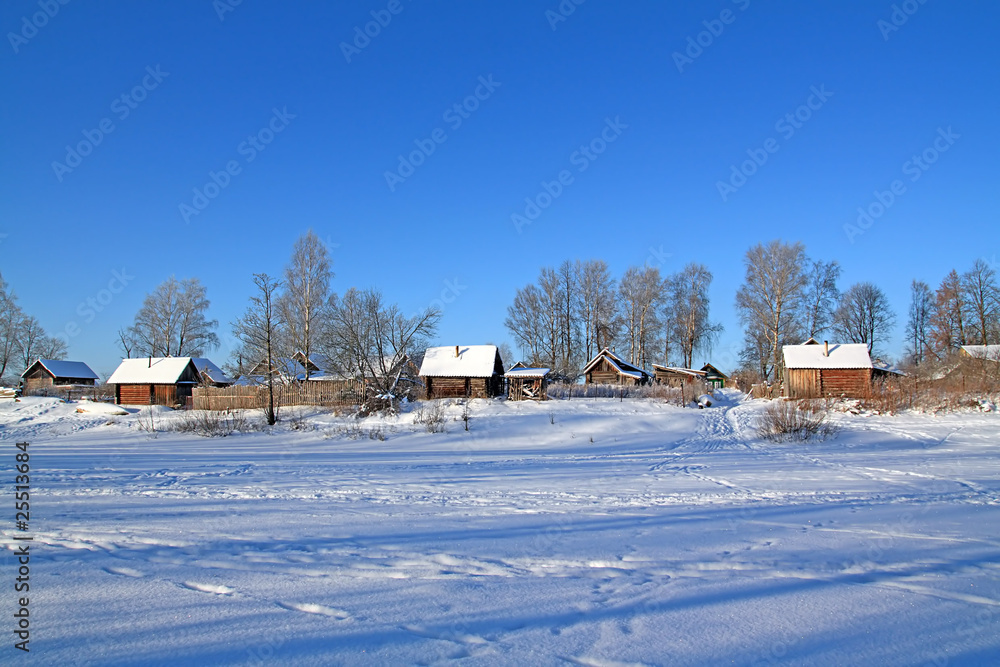 buildings in snow on coast river