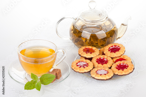 Cup of tea with mint and pastries.