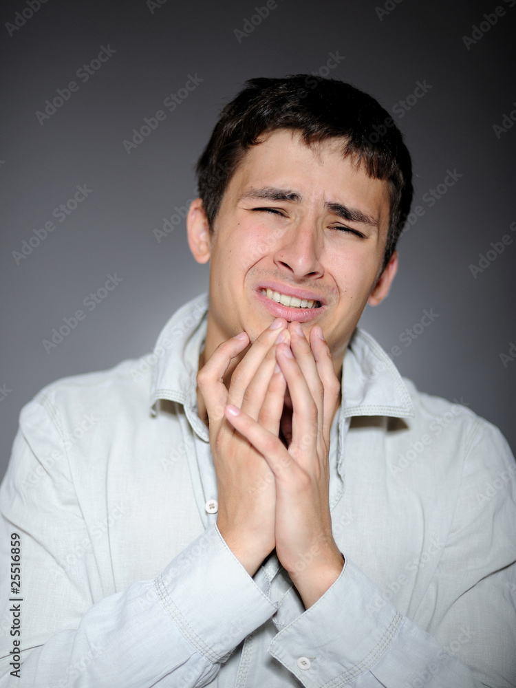 Expressions. Handsome young man feeling fear and crying Expressions. Handsome young man feeling fear and crying