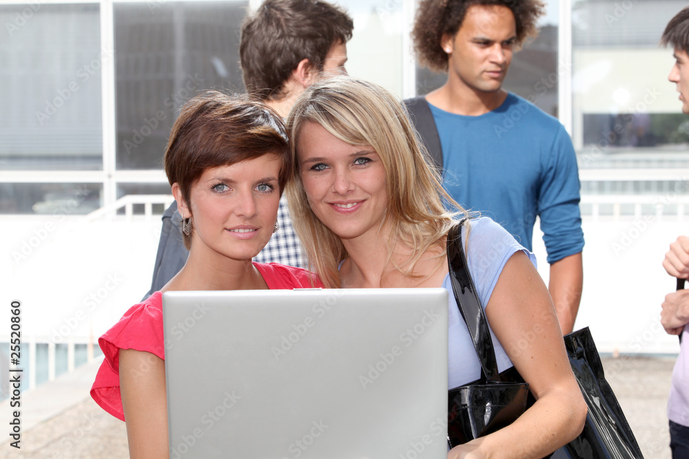 Students at college campus with laptop computer Students at college campus with laptop computer
