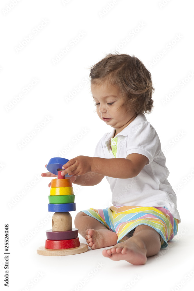 Toddler girl playing with colored bricks Toddler girl playing with colored bricks